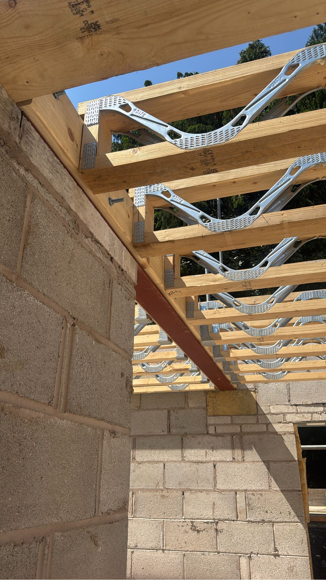 Engineered floor joists and web plates over blockwork and structural steel on a live Built Clear build.