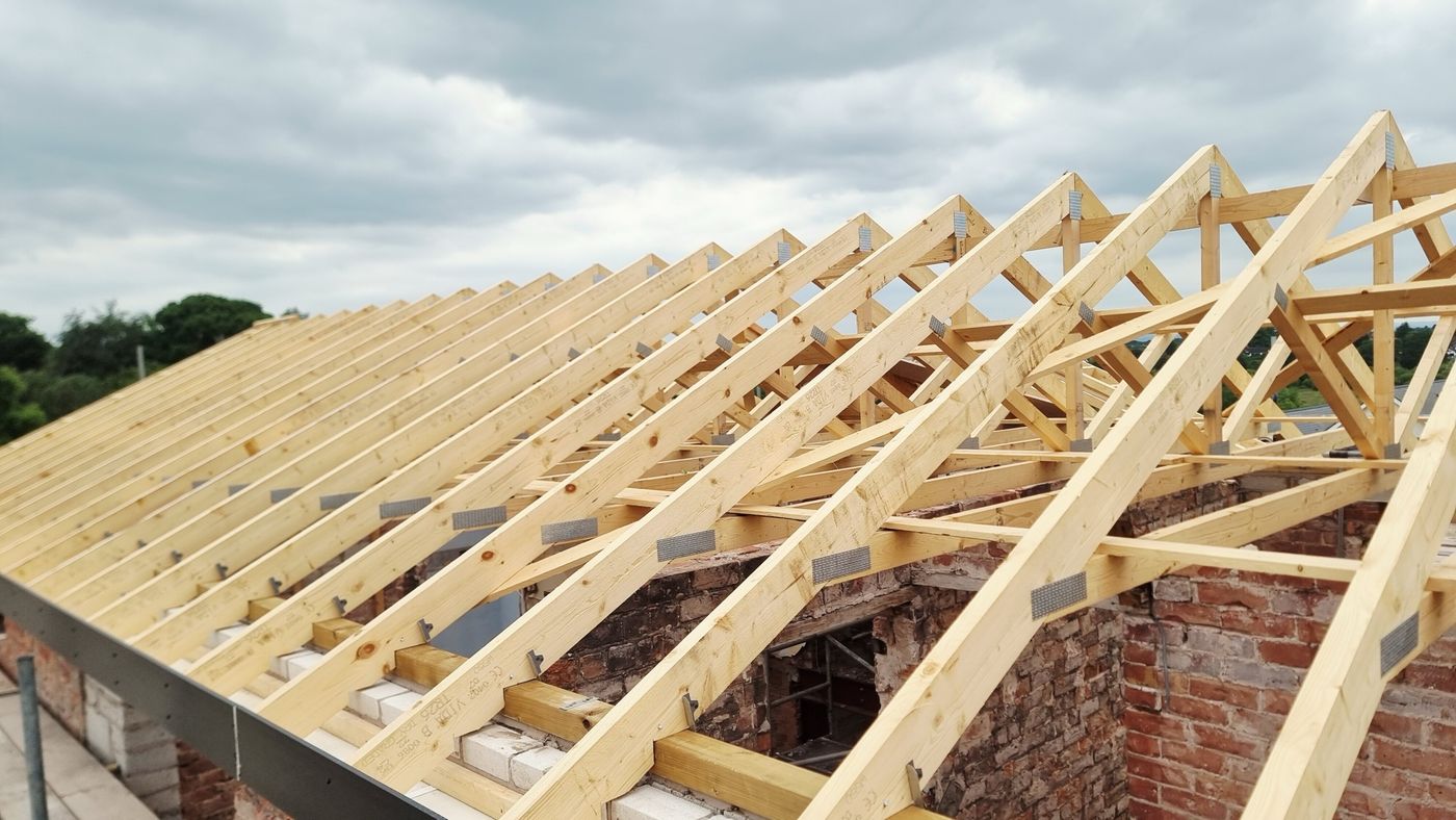 Timber roof trusses during construction, from Built Clear's project archive